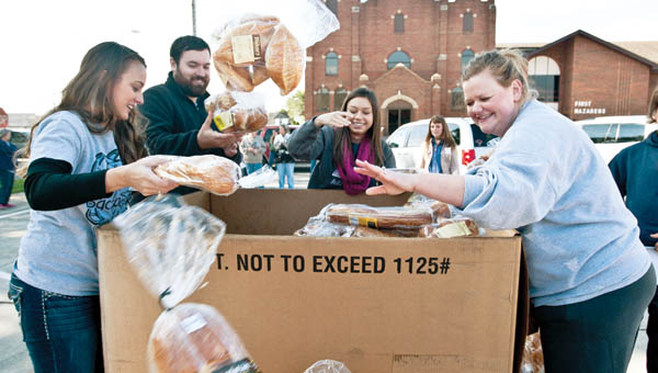 IRONTON TRIBUNE/JESSICA ST JAMES Volunteers gather in front of Ironton’s First Nazarene Church, located on the corner of South Fourth and Pleasant streets, on Thursday to help with a mobile food pantry.