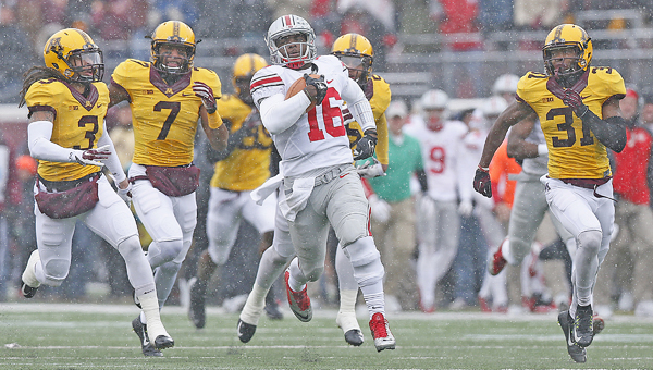 Ohio State Buckeyes quarterback J.T. Barrett (16) leaves the Gophers defenses in the dust as he races for the Buckeyes first touchdown against Minnesota at TCF Bank Stadium in Minneapolis. The Buckeyes won 31-24. (Chris Russell/Columbus Dispatch/MCT)
