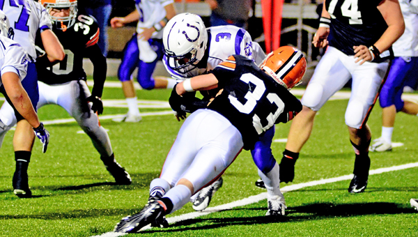 Ironton Fighting Tigers’ linebacker Jeremy Bodmer (33) makes the stop on Martins Ferry running back Arjay Burress. Ironton plays at 7 p.m. Saturday in the Region 17 Division V semifinals to be held at Portsmouth’s Trojan Coliseum. (Kent Sanborn of Southern Ohio Sports Photos)
