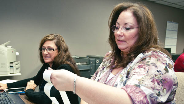 THE TRIBUNE/JESSICA ST JAMES Cathy Overbeck, right, and Cindy Ramsey, left, download election results Tuesday evening.