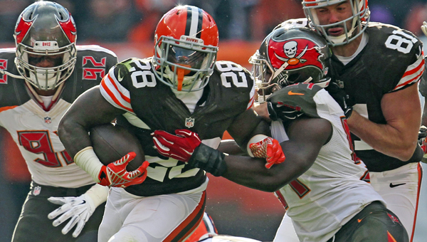 Cleveland running back Terrance West (28) tries to break away from a Tampa Bay defender during the second quarter on Sunday at FirstEnergy Stadium in Cleveland. The Browns won 22-17. (MCT Direct Photo)