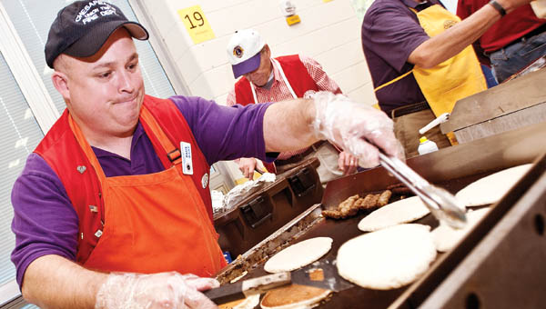 THE TRIBUNE/JESSICA ST JAMES (ABOVE) Paul Hart works the grill during the annual Chesapeake-Proctorville-Rome Lions Club pancake breakfast on Saturday.