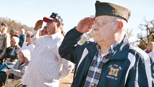 THE TRIBUNE/JESSICA ST JAMES Tom Stambaugh, post commander of the VFW 8850, stands at attention during the playing of taps.