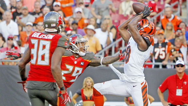 Cincinnati Bengals wide receiver A.J. Green (18) makes a 13-yard touchdown catch, which went on to be the game winner, on a pass from Bengals quarterback Andy Dalton (14), beating Tampa Bay Buccaneers free safety Dashon Goldson (38) and cornerback Leonard Johnson (29) to take the lead during the third quarter on Sunday. The Bengals won 14-13. (MCT Direct Photo)