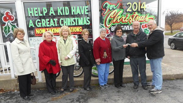 The Tribune/Brandon Roberts The Child Welfare Club presents a check for $265 to co-organizers of the Lawrence County Bicycle Giveaway John Dickess, second from right, and Don Schwartz, far right. The money will be used to buy bikes for the giveaway on Saturday. Pictured, from left, are Child Welfare Club members Janice Haeberlin, Jane Morris, Mary Laber, Sandy Cloran, Madolin Blackwell and Nancy Corn.