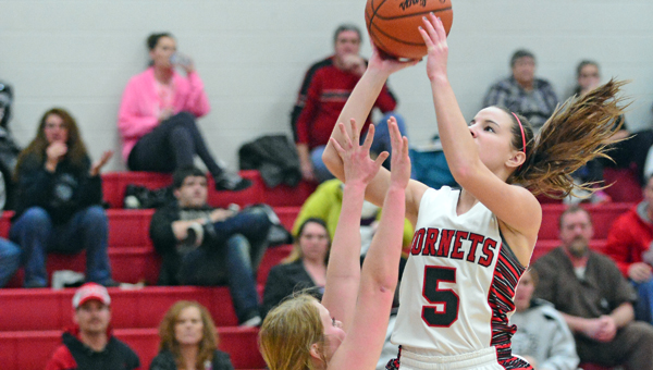 Coal Grove Lady Hornets’ Kaylee Beals (5) leaps above Chesapeake Lady Panthers’ Natalie Hall to take a jump shot during Monday’s game. Coal Grove won 52-42. (Kent Sanborn of Southern Ohio Sports Photos)
