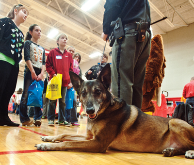 Hemi, the Lawrence County Sheriff’s Office drug dog, takes a breather while his master, Deputy Steve Wilson, talks about law enforcement.