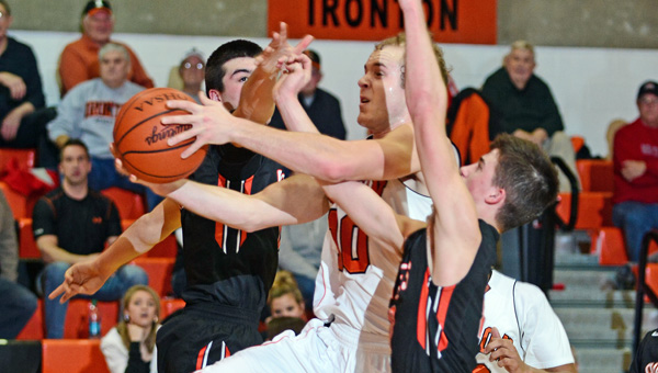 Ironton Fighting Tigers’ Joe Bowling drives for a layup while being fouled by two Wheelersburg defenders. Ironton beat Wheelersburg 59-49 on Tuesday. (Kent Sanborn of Southern Ohio Sports Photos)