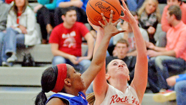 Rock Hill Redwomen guard Madison Damron (2) scores against a Portsmouth defender during Thursday’s game. Damron had 11 points as Rock Hill won 62-54 on Senior Night. (Robert S. Stevens & The Gold Studio of Ironton)