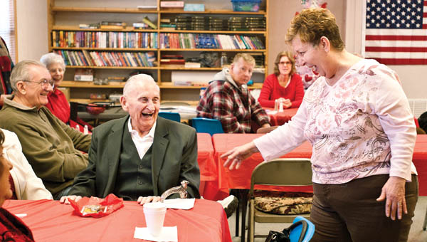 Coordinator Darlene Green laughs with Ray Eplin as they and others share their Valentine’s Day stories during a party at the new Chesapeake Senior Center, located alongside the Chesapeake Community Center, Friday.