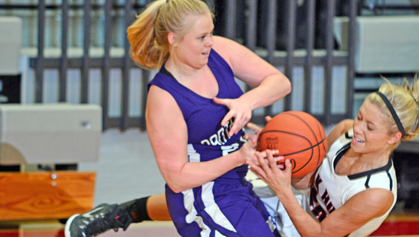 Chesapeake Lady Panthers’ Sydnee Hall (left) battles with Oak Hill Lady Oaks’ Abby Haislop (right) for the basketball during Sunday’s Division III sectional tournament game. Chesapeake beat Oak Hill 52-42. (Kent Sanborn of Southern Ohio Sports Photos)