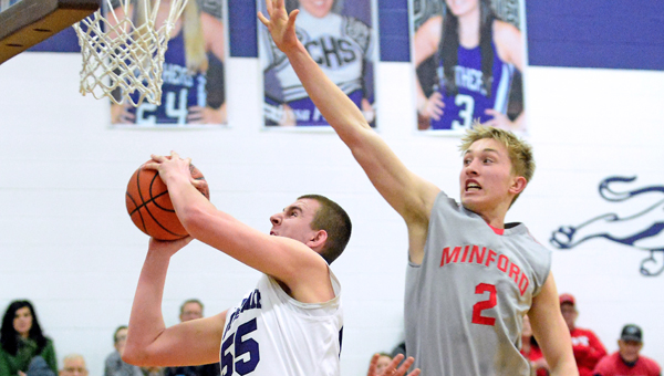 Chesapeake Panthers’ center Aaron Thompson (55) scores inside despite an attempt to block the shot by Minford’s Kenton Gullion (2). Chesapeake won 56-48 in overtime on Tuesday. (Kent Sanborn of Southern Ohio Sports Photos)