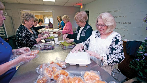 Members of the Child Welfare Club pack takeout lunches last week during one of the club’s annual fundraisers. In April the club will offer a second lunch for guests at the First Church of the Nazarene.