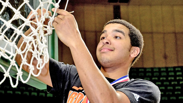 Ironton senior guard Johnny Johnson cuts down a piece of the net after the Fighting Tigers won the Division III district title. (Kent Sanborn of Southern Ohio Sports Photos)