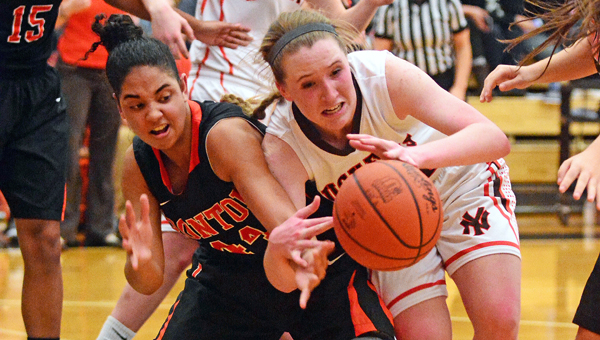 Ironton Lady Fighting Tigers’ Cheyenne Scott (left) battles Nelsonville-York Kaitlyn Hurd for a loose ball. Ironton plays Fort Frye and Fairland plays Wheelersburg in the Division III regional tournament Wednesday at Logan. (Kent Sanborn of Southern Ohio Sports Photos)