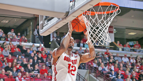 Ohio State Buckeyes’ Sam Thompson (12) goes high in the air to slam home a dunk. The Buckeyes rallied to beat Purdue 65-61 on Sunday in a Big Ten game. (MCT Direct Photo)
