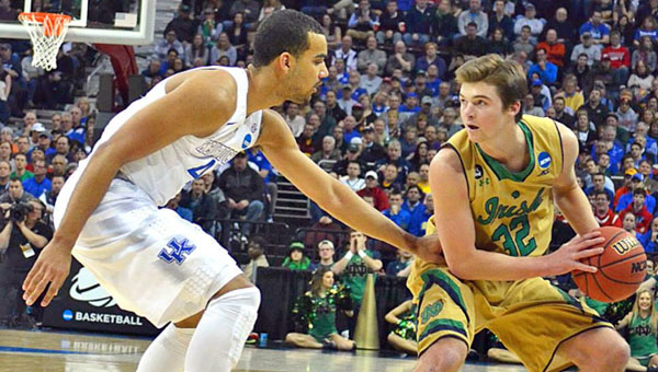 Notre Dame Fighting Irish guard Steve Vasturia (32) is guarded by Kentucky Wildcats’ Trey Lyles during Saturday’s NCAA Division I regional championship game. The No.1-ranked Wildcats rallied to escape with a 68-66 win. (Photo Courtesy Mike Caldwell/Publisher & President Leader Publications)
