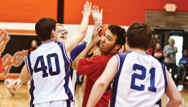 A Cardinal from Vern Riffe finds himself surrounded during a basketball game against the Open Door School Jets Thursday at the Conley Center at Ironton High School.