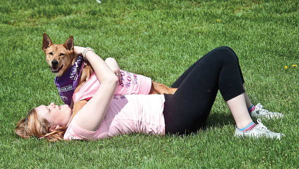 Kassi Roble and her Chihuahua shepherd mix, named Abbie, share a moment together during the Bark for Life event at the Lawrence County Fairgrounds on Saturday.