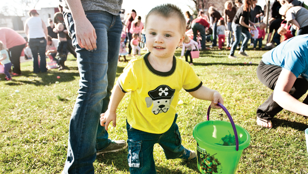 Two-year-old Kolben Scarberry is on the hunt at the annual Easter egg hunt, at the Lawrence County Courthouse, Tuesday evening.