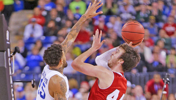 Wisconsin's Frank Kaminsky (44) scores over Kentucky's Willie Cauley-Stein (15) in the NCAA Tournament national semifinal at Lucas Oil Stadium in Indianapolis on Saturday, April 4, 2015. Wisconsin advanced, 71-64. (Mark Cornelison/Lexington Herald-Leader/TNS)