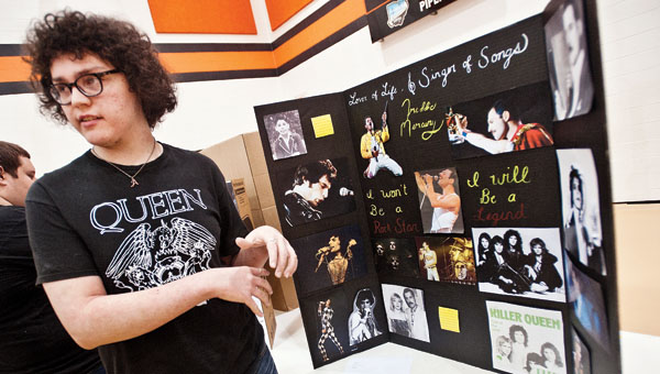 Noah Ratliff talks about his project on Freddie Mercury during the Ironton High School Social Studies Fair Wednesday. Project themes included on Adolph Hitler, David Koresh, Alcatraz Island, moon landing and conspiracies.