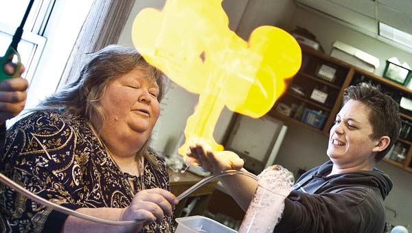 Hydrogen gas bubbles explode in color from the hand of Raceland Worthington High School student Dawson Hamm during a science day event at Ohio University Southern. Students also took part in a CSI class, created homemade bouncy balls and lava lamps and learned about electricity.