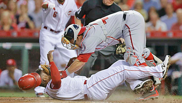 Cincinnati's Marlon Byrd scores ahead of the tag by Washington Nationals' catcher Wilson Ramos during the sixth inning of Friday's game. The Reds won 5-2. (Courtesy of the Cincinnati Reds.com)