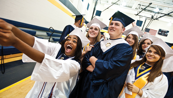 Students from the 2015 South Point High School graduating class take a selfie before the start of commencement exercises on Sunday.