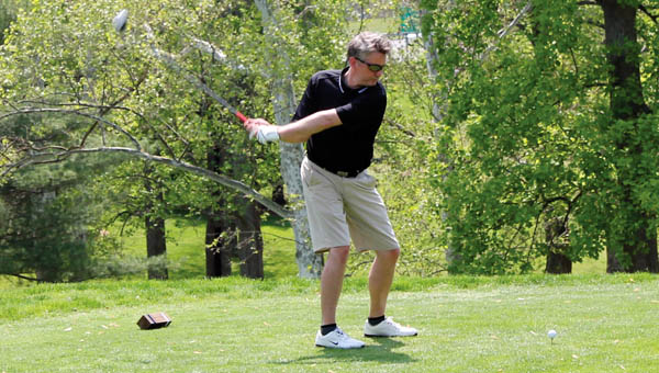 Team members watch one of their teammates before a putt during the 12th annual Bernard L. Edwards Memorial Golf Tournament hosted by Ohio University Southern Monday afternoon at the Guyan Golf and Country Club.