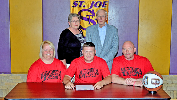 St. Joseph Flyers’ senior guard Zack Kelly signed a letter-of-intent to play basketball at Muskingum University. Attending the ceremony were: seated from left to right, mother Tracy Kelly, Zack, and father Chad Kelly; standing from left to right, grandparents Kay and Tom Kelly. (Kent Sanborn of Southern Ohio Sports Photos)