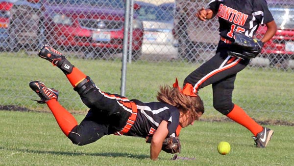 Ironton Lady FIghting Tigers’ outfielder Taylor Monk dives for the ball while Zjaytia Black-Mize provides backup during Friday’s Division III sectional tournament game. Minford held off Ironton to win 11-9. (Tim Gearhart of Tim’s News & Novelties, Park Ave. in Ironton)