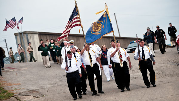 American Legion Post 433 leads participants down to the Center Street Boat Landing, in Ironton during the annual Navy Night Memorial Service event Thursday.