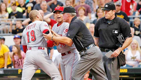 Cincinnati’s Joey Votto (19) is restrained by third base umpire Ted Barrett and Reds’ manager Bryan Price while arguing with home plate umpire Chris Conroy after being ejected in the third inning of Wednesday’s game. (Courtesy of The Cincinnati Reds.com)