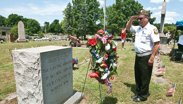 Dave Johnson with the VFW Post 8850 Honor Guard performs the placement of the memorial wreaths during the Veterans Memorial Service on Sunday.