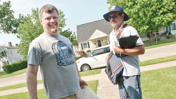 Ryan Munion, left, and Don Johnson, right, are on foot patrol as they deliver mail and pick up donated food items for the nationwide Stamp Out Hunger Food Drive Saturday in Ironton. The drive is in it’s 23rd-year and donated items will be split between BackPack Buddies and the local city mission.
