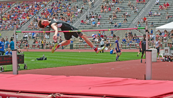 Coal Grove Hornets’ senior Brandon Adkins clears the cross bar on his way to winning a second straight Division III state championship in the high jump on Friday at Jesse Owens Memorial Stadium. (Jimmy Walker/The Ironton Tribune)