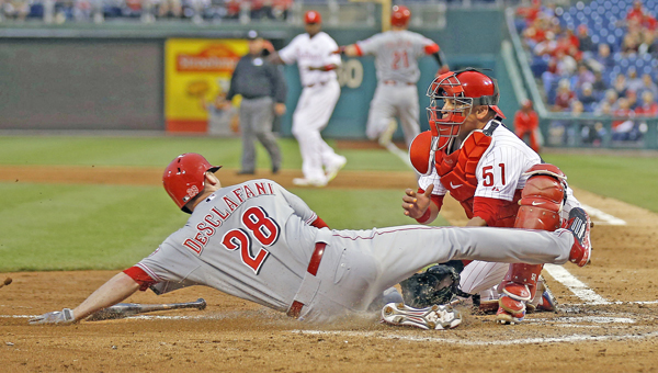 Philadelphia Phillies catcher Carlos Ruiz tags out the Cincinnati Reds’ Anthony DeSclafani at home plate in the fifth inning at Citizens Bank Park in Philadelphia on Thursday. The call was reversed due to catcher’s obstruction. The Reds won 6-4. (MCT Direct Photo)