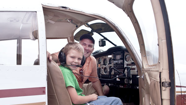 Eight-year-old Colton Noble gets ready for a ride in the sky with pilot Fred Hitchings during a community fly day on Saturday at the Lawrence County Airpark.