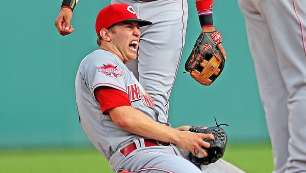 Cincinnati Reds’ pitcher Jon Mascot winces in pain after he dislocated his non-throwing shoulder tagging out the Detroit Tigers' Anthony Gose during a rundown play in the first inning of Monday's game. The Reds lost 6-0. (MCT Direct Photo)