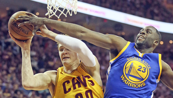 The Cleveland Cavaliers’ Timofey Mozgov (20) grabs a rebound in front of the Golden State Warriors’ Draymond Green during the second quarter in Game 4 of the NBA Finals at Quicken Loans Arena in Cleveland on Thursday. (MCT Direct Photos)