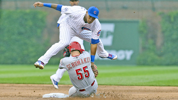 Chicago Cubs second baseman Addison Russell tags out the Cincinnati Reds' Skip Schumaker (55) trying to steal second base during the second inning at Wrigley Field in Chicago on Friday. The Reds won 5-4 in 10 innings. (MCT Direct Photo)