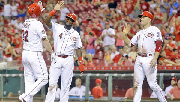 Jay Bruce (left) is congratulated by Brandon Phillips (4) and Joey Votto after hitting a three-run homer in the eighth inning on Saturday. Bruce drove in all four runs as the Reds lost 9-4 to the Cleveland Indians. (Courtesy of the Cincinnati Reds.com)
