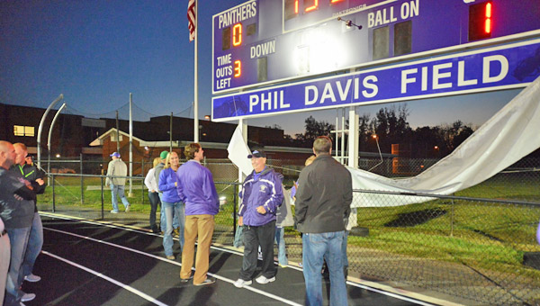 Former Chesapeake Panthers' Hall of Fame football coach Phil Davis died on Friday at the age of 69. Chesapeake held a dedication ceremony in 2013 by naming the field in his honor. Davis is standing under the sign in his honor. (Kent Sanborn of Southern Ohio Sports Photos.com)