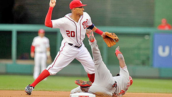 Cincinnati’s Brandon Phillips (right) is forced out at second base by Washington’s Ian Desmond during the first inning of Monday’s game. The Reds beat the Nationals 3-2 on a home run by Eugenio Suarez. (Courtesy of The Cincinnati Reds.com)