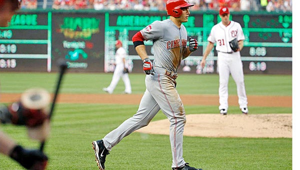 Cincinnati Reds’ first baseman Joey Votto rounds third base after hitting a solo home run in the third inning off Washington’s Max Scherzer. Votto drove in three runs and Johnny Cueto pitched a complete game two-hitter as the Reds blanked the Nationals 5-0. (Courtesy of The Cincinnati Reds.com)