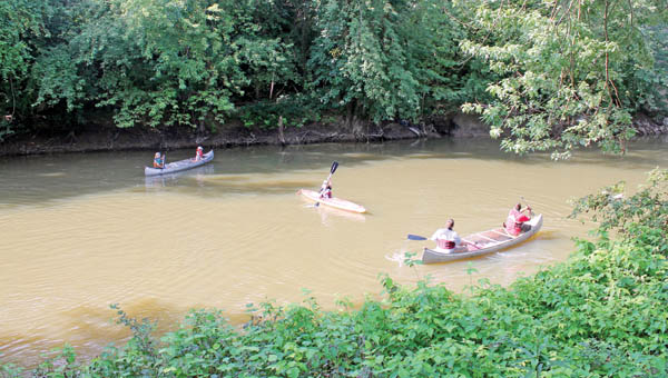 Participants take part in the annual canoe caper event Saturday hosted by the Symmes Creek Restoration Committee.