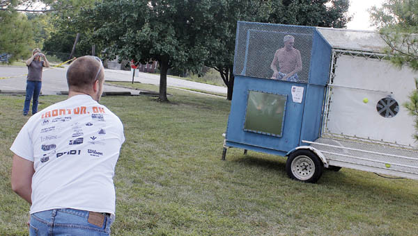 Liebert worker Garrett Foster’s throw to the dunk tank is on target, soaking Liebert maintenance manager Pat Burke Thursday morning at the company carnival.