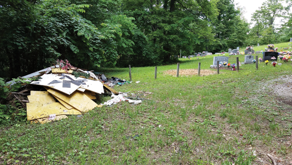 Piles of trash were dumped at Ross Cemetery in Kitts Hill in June. The person responsible was cited to court by the Lawrence-Scioto Solid Waste Management District.