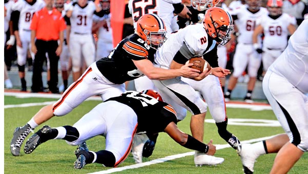 Ironton Fighting Tigers’ Desmond Young (32) and Tanner Wilson (88) bring down Wheelersburg Pirates’ quarterback Kyle Davis (2) during Friday’s season opener at Tanks Memorial Stadium. Ironton fell 14-6. (Kent Sanborn of Southern Ohio Sports Photos)